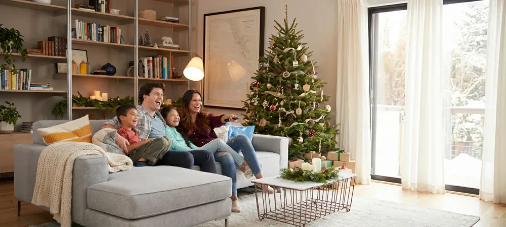 happy family in living area by christmas tree