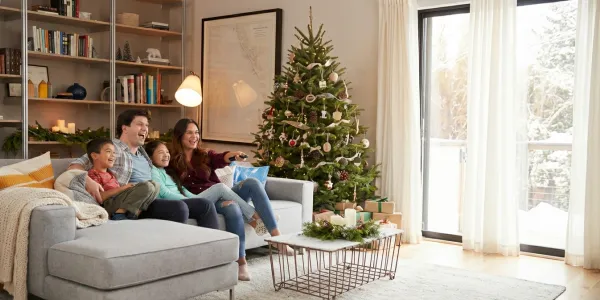 happy family in living area by christmas tree